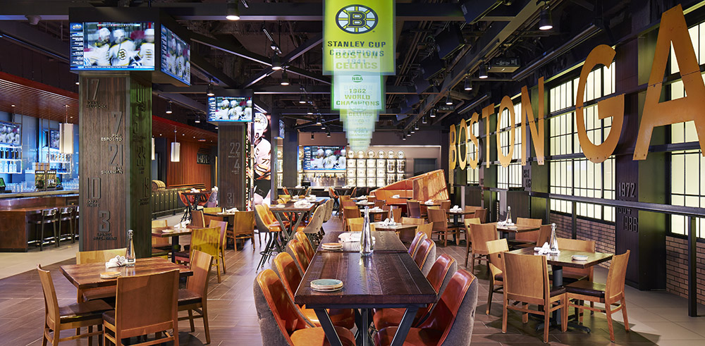 Modern sports bar with wood tables and bar by Ferrante Manufacturing Co. in Detroit, MI